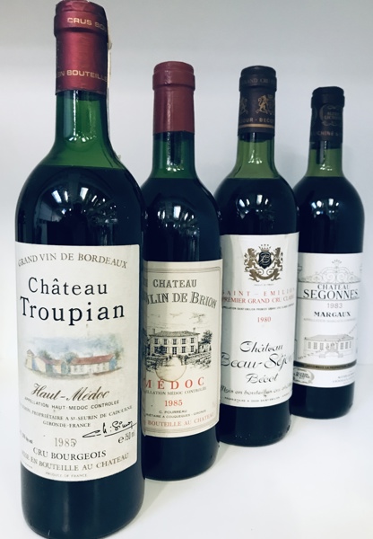 4 fl. rødvin: Chateau Beau-Sejour Becot Saint-Emilion (1980) Grand Cru, Chateau Segonnes Margaux (1983), Château Troupian Haut-Medoc (1985) samt Château Moulin de Brion Médoc (1985) 