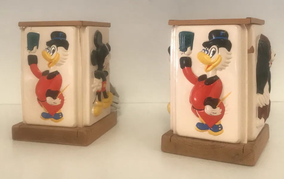2 Vintage Disney- børnelamper (ofte produceret af mærket OLUK i 1950'erne-1970'erne), som har en firkantet, oplyst skærm m. relieffigurer af klassiske Disney figurer som Mickey Mouse og Onkel Joakim